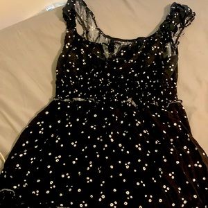 black floral dress with ruffle bottom and cinched waist